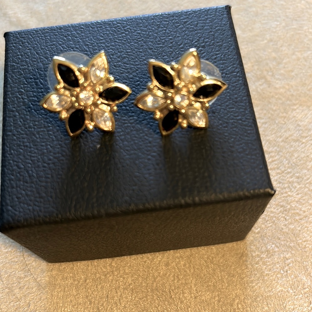 Gold tone stud earrings with blue and clear stones.